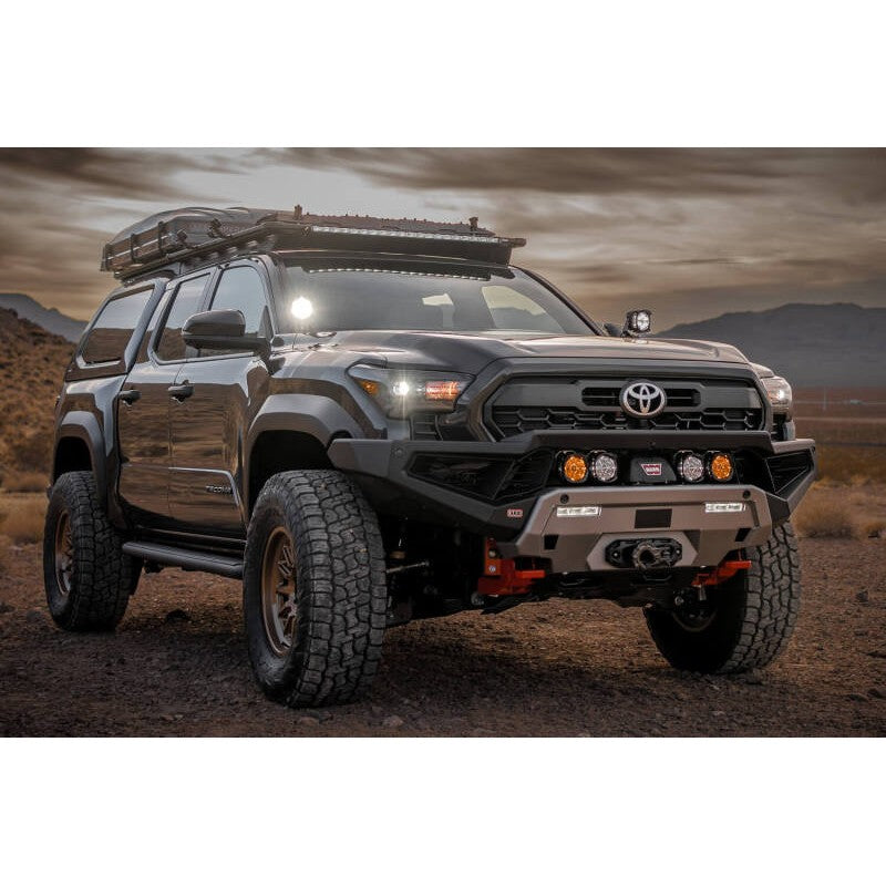 ARB Zenith Winch Bar in textured black with red recovery points installed on a 2024 Toyota Tacoma.