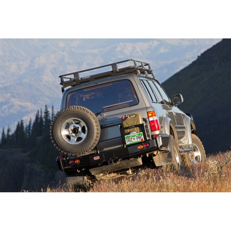Textured black ARB Summit Rear Bumper with integrated tow hitch and jack points for 80 Series Toyota Land Cruiser.