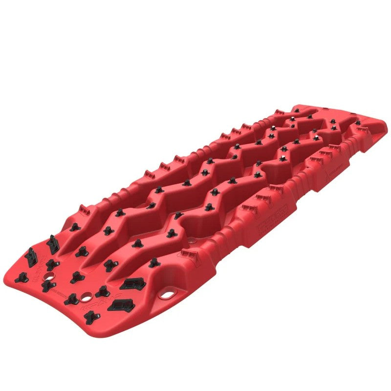 Pair of red ARB TRED Pro recovery boards featuring black composite teeth and integrated shovel handles.