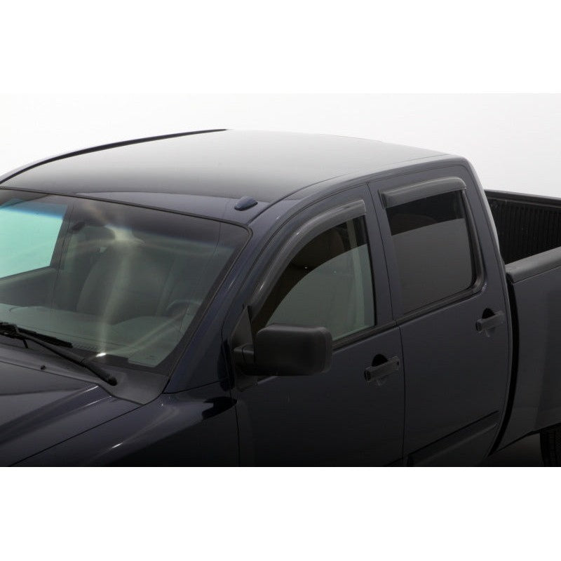 AVS Smoke Original Ventvisor outside mount window deflectors installed on a Nissan Titan Crew Cab 4-door pickup.