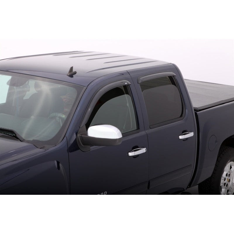 Smoke-tinted AVS Ventvisor window deflectors installed on the doors of a Chevrolet Silverado Extended Cab truck.