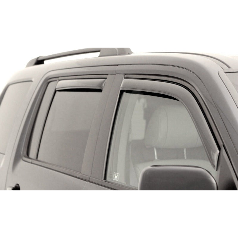 Four AVS In-Channel Ventvisor window deflectors in a dark smoke finish for GMC Acadia and Saturn Outlook