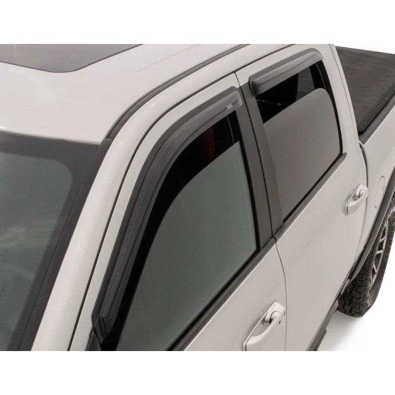 Set of four AVS smoke-tinted outside mount window deflectors for a Dodge Ram Crew Cab pickup truck.
