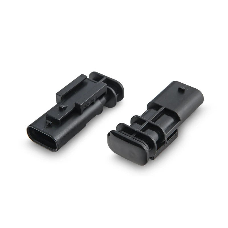 AWE Tuning electronic valve simulator modules with factory-style electrical connectors for exhaust valve deletes.