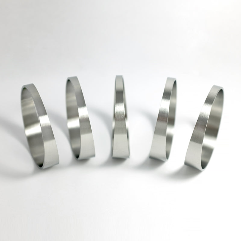 Five 2.75-inch stainless steel pie cuts with a 1D tight radius for custom exhaust fabrication.