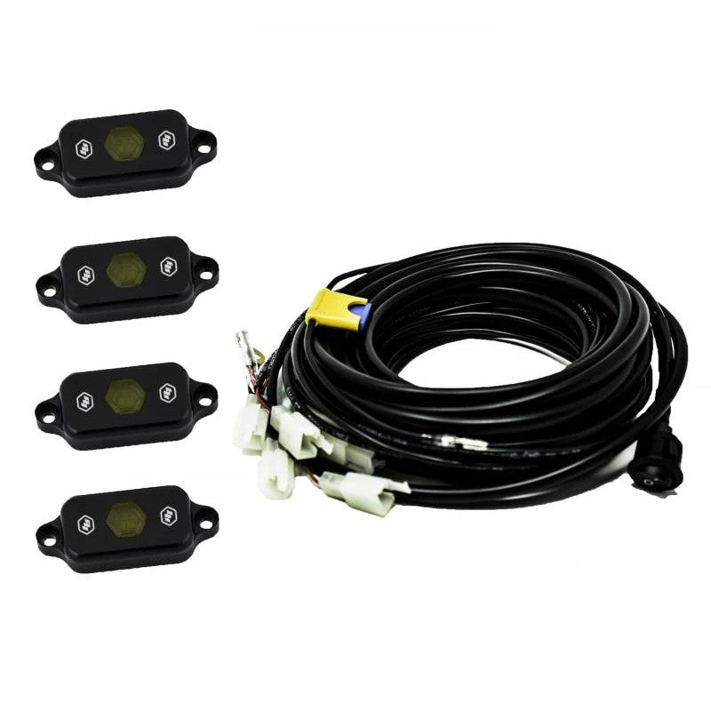 Baja Designs universal amber LED rock light pods with mounting hardware and wiring harness.