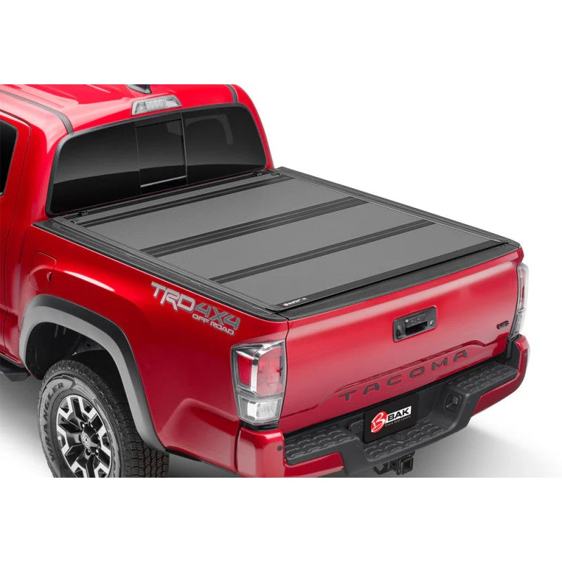 BAK BAKFlip MX4 matte black hard folding tonneau cover installed on a Toyota Tacoma with a 6-foot bed.