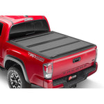 BAK BAKFlip MX4 matte black hard folding tonneau cover installed on a Toyota Tacoma with a 6-foot bed.
