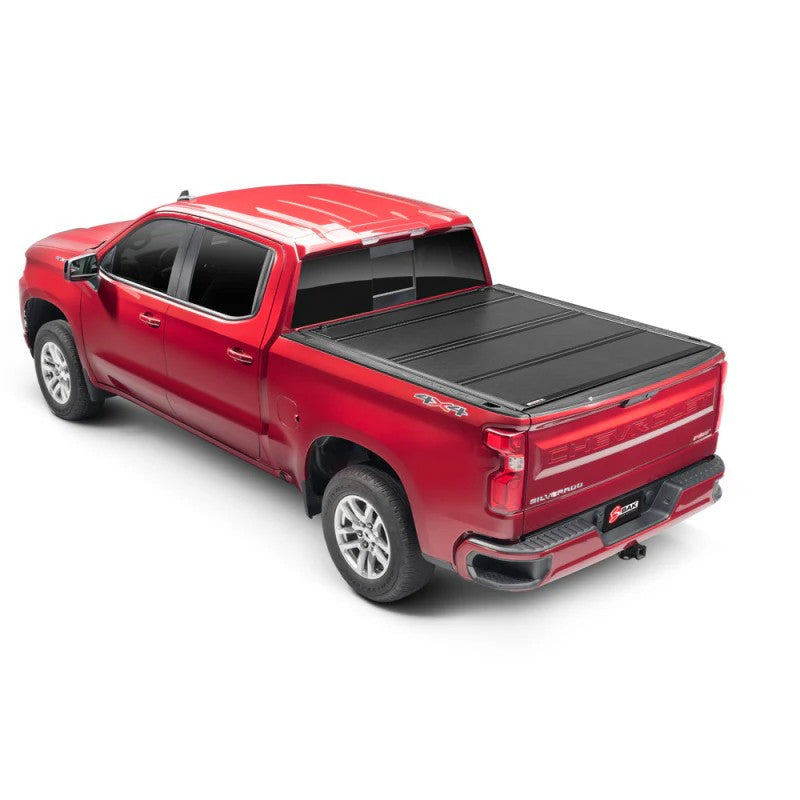 BAKFlip G2 semi-gloss black hard folding truck bed cover installed on a Chevrolet Silverado with a 6' 6" bed.