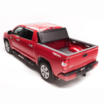 BAK BAKFlip G2 black aluminum hard folding truck bed cover installed on a 2024-2026 Toyota Tacoma with 5ft bed.