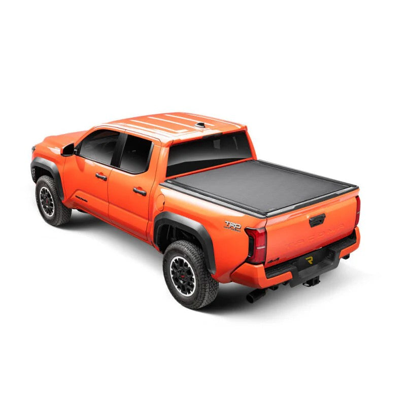 Matte black BAK Revolver X4ts hard roll-up tonneau cover with integrated T-slot rails installed on a Toyota Tacoma 5ft bed.