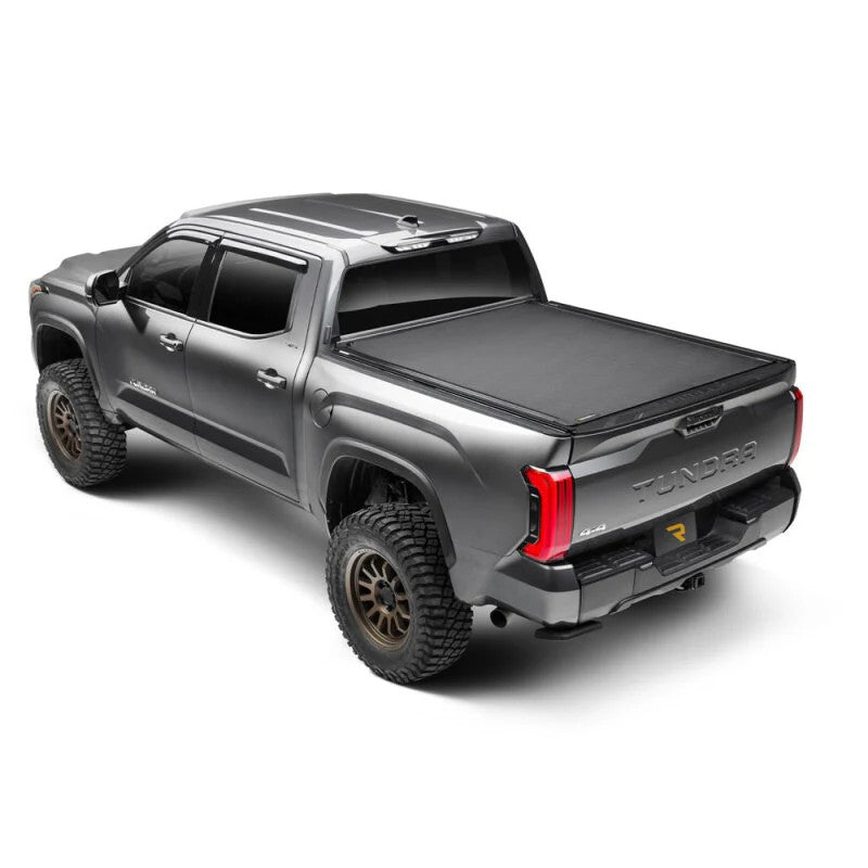 BAK Revolver X4ts matte black hard roll-up truck bed cover with T-slot rails installed on a Toyota Tundra.