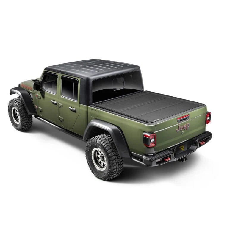 BAK BAKFlip MX4 TS matte black hard folding truck bed cover with T-slot rails installed on a Nissan Frontier 5ft bed