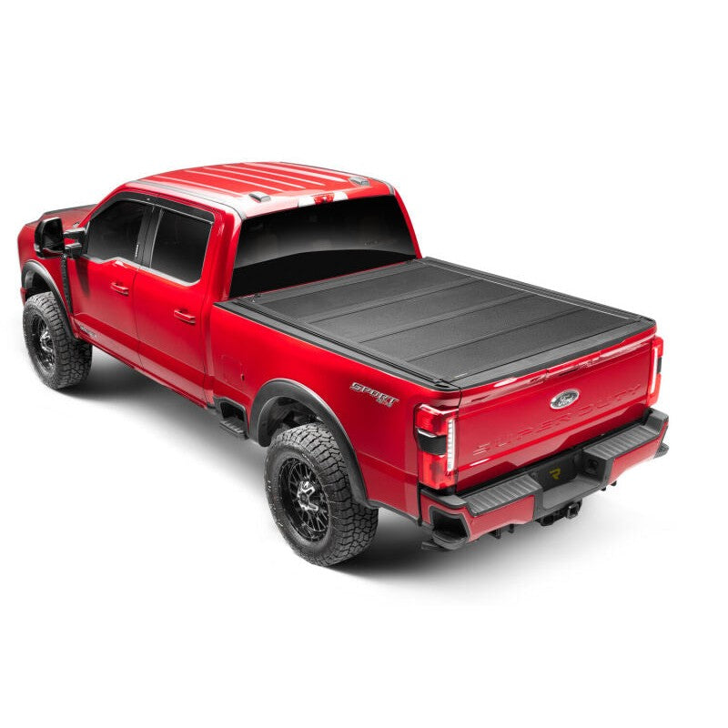 BAK BAKFlip MX4 TS matte black hard folding bed cover with integrated T-slot rails on a 2024-2025 Toyota Tacoma 6ft bed.