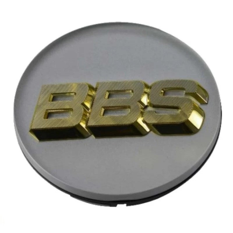 White BBS wheel center cap with a 3D gold logo and 4-tab mounting clips on the reverse side.