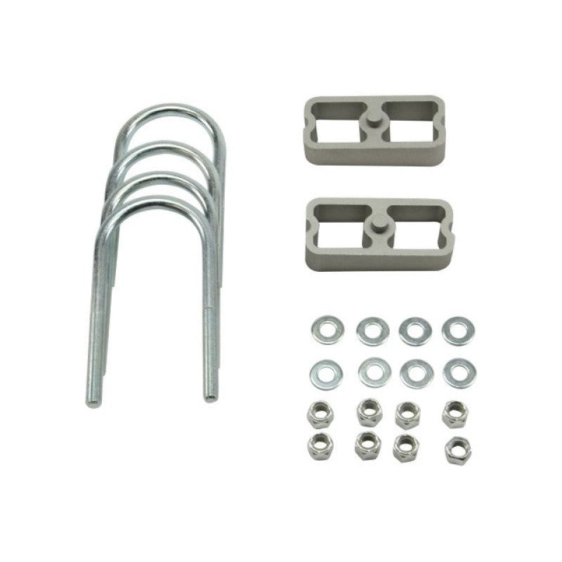 Belltech 1-inch extruded aluminum lowering blocks with 2-degree taper, U-bolts, and Grade 8 mounting hardware.