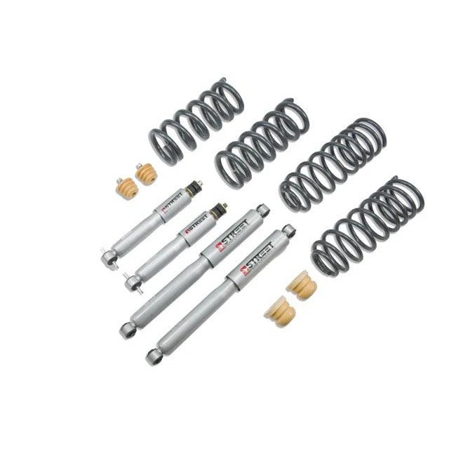 Belltech Street Performance lowering kit featuring four silver shock absorbers, black lowering components, and hardware.