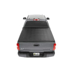 Bestop EZ-Fold black vinyl tri-fold soft tonneau cover installed on a Toyota Tacoma with a 6-foot bed.