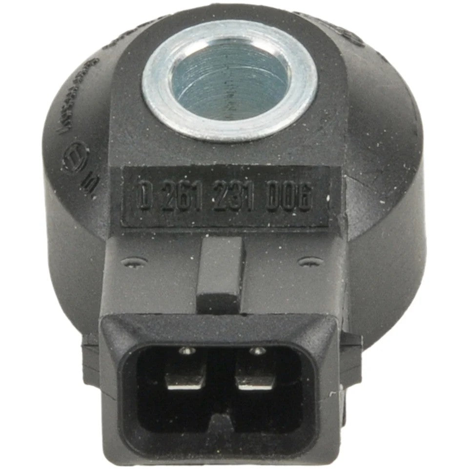 Bosch engine knock sensor featuring a black polymer housing with a central metal mounting bore and electrical connector.