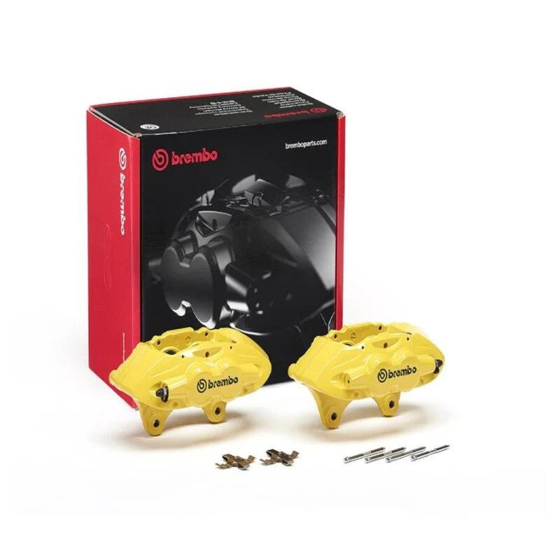 Pair of yellow Brembo X-Style hydraulic front brake calipers with included installation hardware pins and springs.