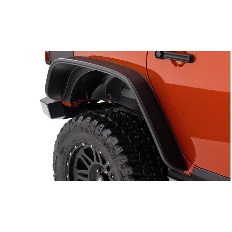 Rear pair of matte black Bushwacker Flat Style Fender Flares for 4-door Jeep Wrangler JK Unlimited.