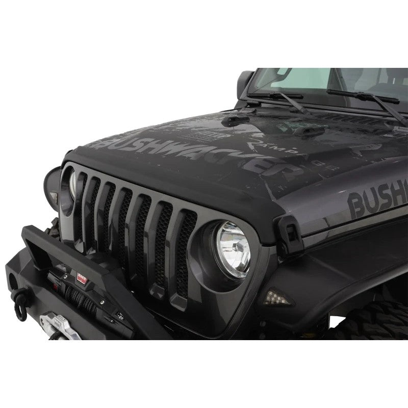 Matte black Bushwacker Trail Armor hood stone guard mounted on the front edge of a Jeep hood.