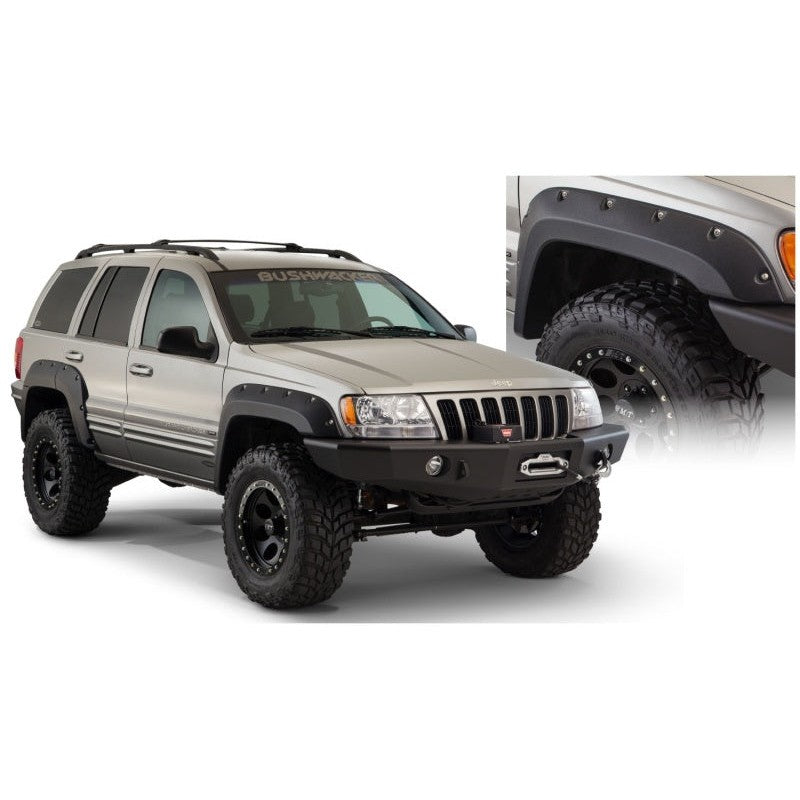 Four Bushwacker Cut-Out Style fender flares in matte black finish for 1999-2004 Jeep Grand Cherokee.