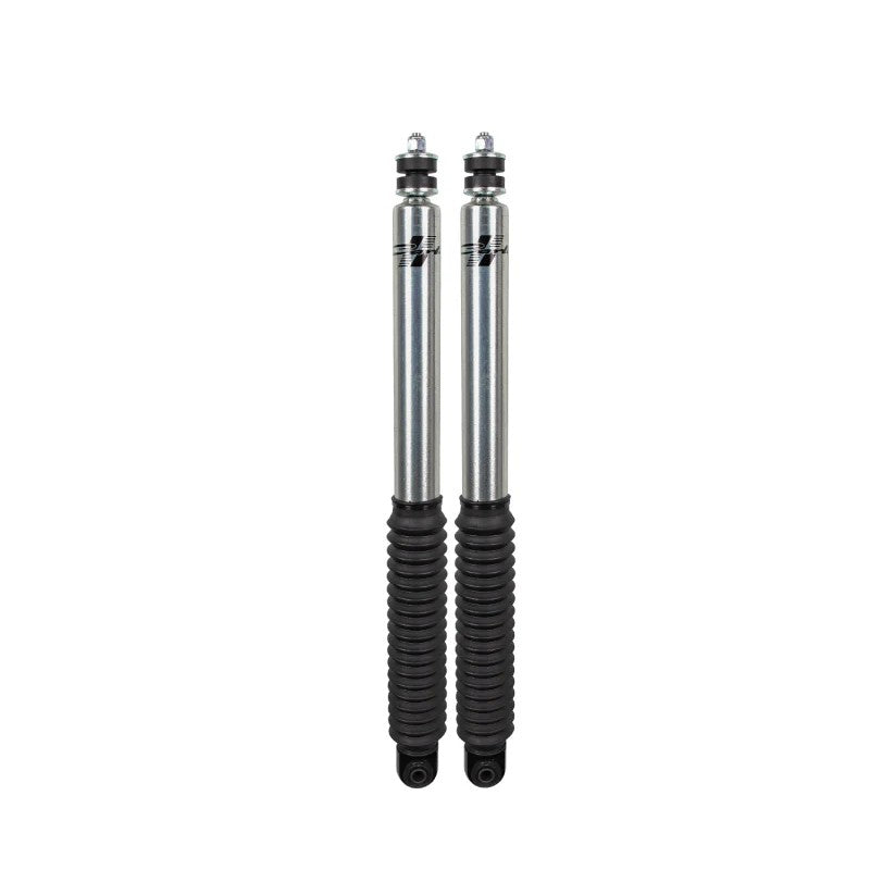 Pair of Carli Signature Series 2.0 silver clear-coated front shocks with black rubber boots for Ford Super Duty trucks