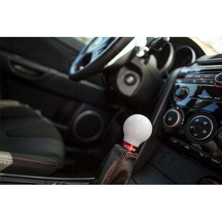 White Cobb shift knob with a race red base for 2006-2013 Mazdaspeed 3 and 6 models