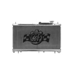 Polished 2-row aluminum radiator for Subaru with TIG-welded tanks and CNC-machined mounting brackets.