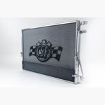 Satin finish aluminum CSF 8154 high-performance heat exchanger with integrated rock guard for BMW and Toyota GR Supra.
