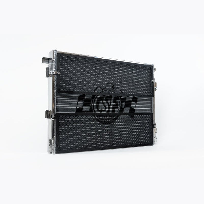 Polished aluminum CSF 8215 front mount heat exchanger with protective black mesh rock guards and mounting brackets.
