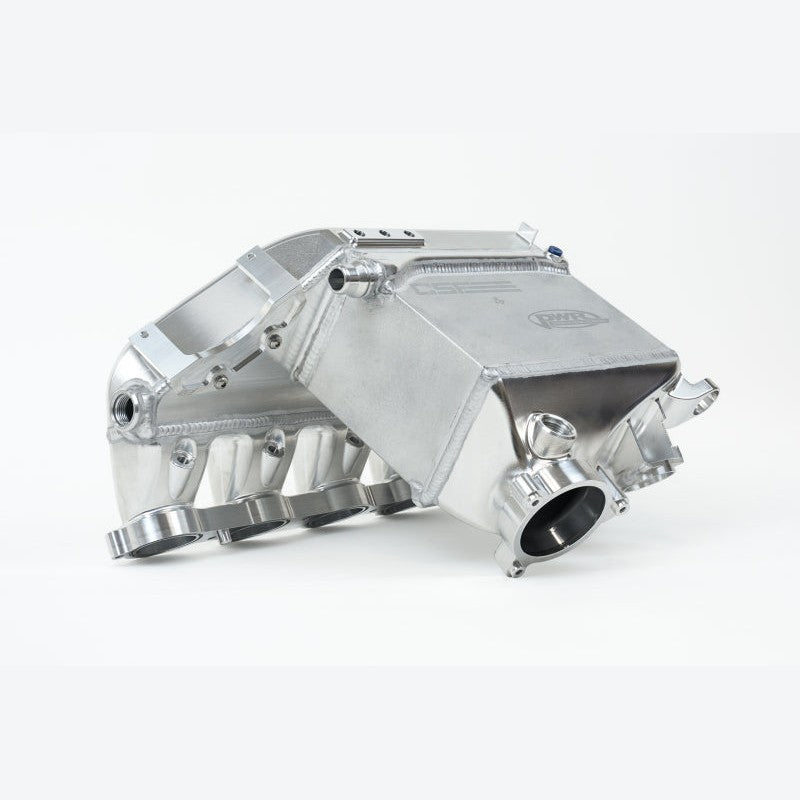 CNC machined raw billet aluminum CSF charge-air cooler manifold for BMW S58 engines showing the PWR core and fuel rail.