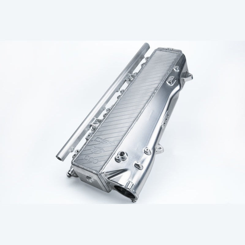 Raw machined billet aluminum charge-air cooler intake manifold for B58 engines featuring integrated fuel rail and ports.