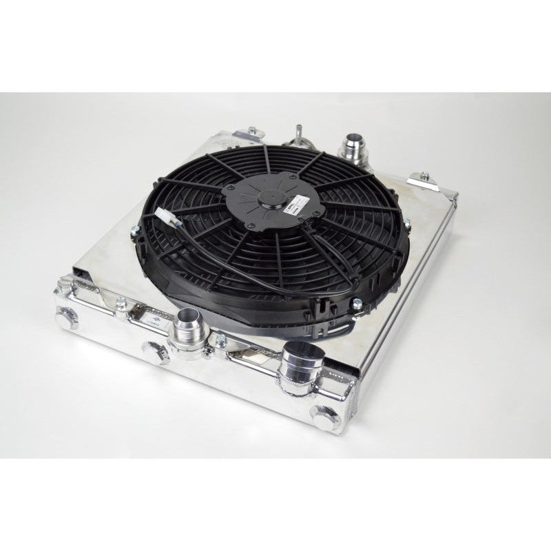 Mirror-polished CSF 2858X aluminum half radiator with 12-inch SPAL cooling fan, shroud, and -16AN fittings.