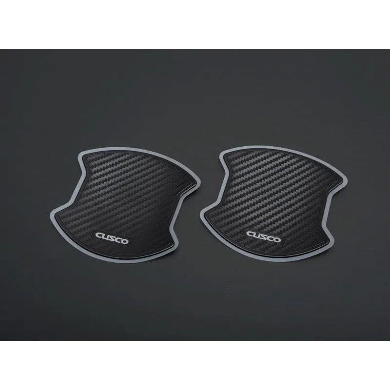 Cusco carbon-fiber style door handle protector films for 2022+ Toyota GR86 and Subaru BRZ.