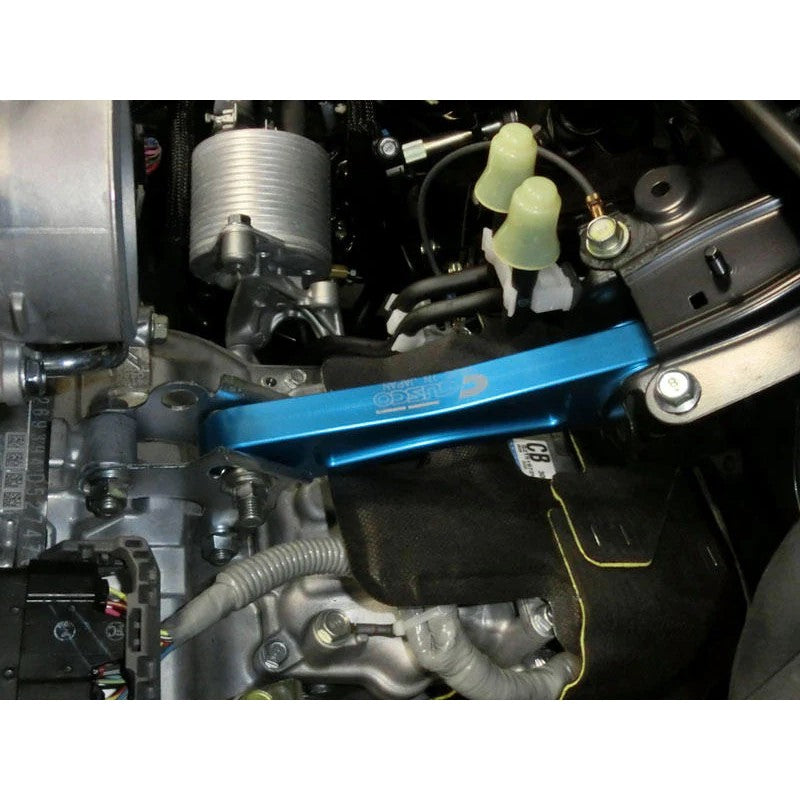 Blue anodized Cusco billet aluminum engine pitching stop with heavy-duty rubber bushings for Subaru EJ20/EJ25.