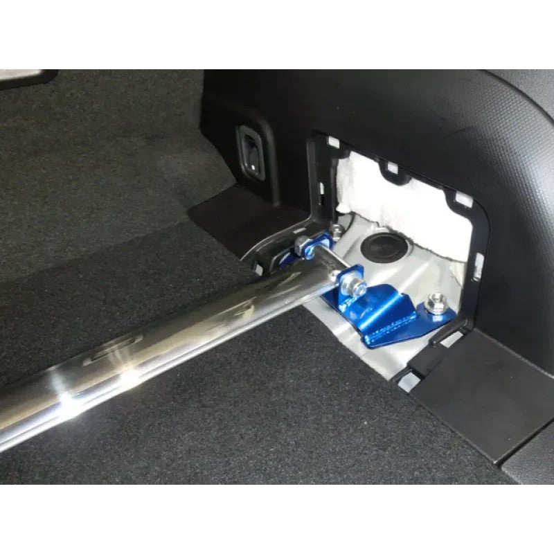 Cusco OS-Type rear strut tower brace with a polished oval aluminum bar and blue mounting brackets.