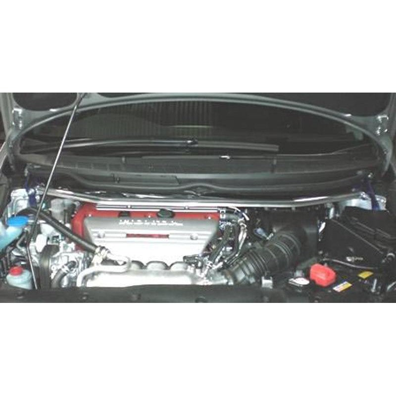 Cusco Type OS front strut tower bar featuring a polished aluminum oval shaft and blue steel end brackets.