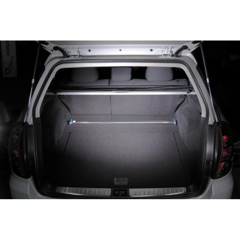 Cusco Type OS rear strut tower bar featuring a polished oval aluminum shaft and blue powder-coated mounting brackets.