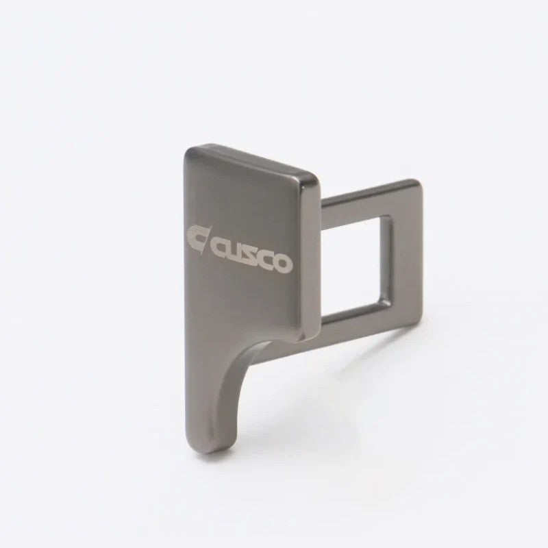 Cusco universal seat belt buckle clip with stamped Cusco logo for competition use.