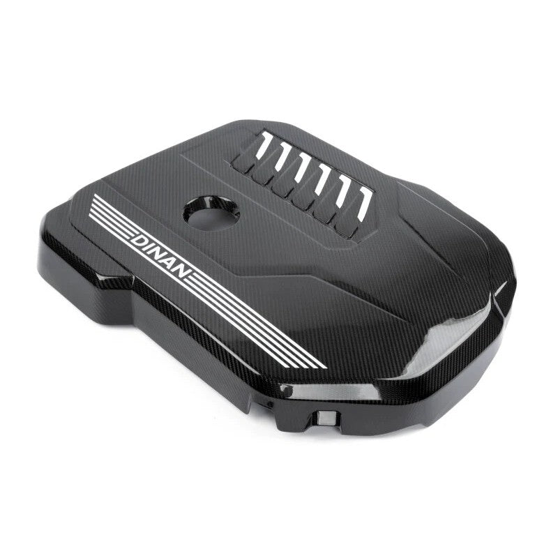 Dinan gloss 2x2 twill carbon fiber engine cover with matte accents and white power stripes for BMW B58 engines.