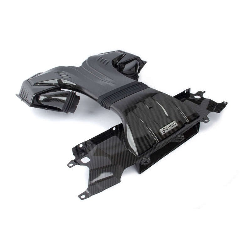 Dinan carbon fiber cold air intake system featuring dual air boxes and central scoop for 2020-2026 BMW M-series SUVs.