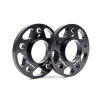 A pair of black anodized Dinan 15mm wheel spacers featuring a 5x112 bolt pattern and 66.5mm center bore.