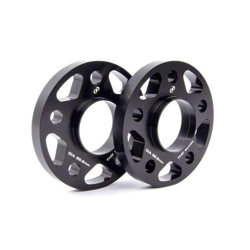 Two black anodized 20mm Dinan wheel spacers with 5x112 bolt pattern and 66.5mm hub-centric center bore.