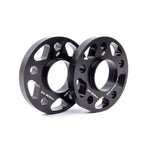 Two black anodized 20mm Dinan wheel spacers with 5x112 bolt pattern and 66.5mm hub-centric center bore.