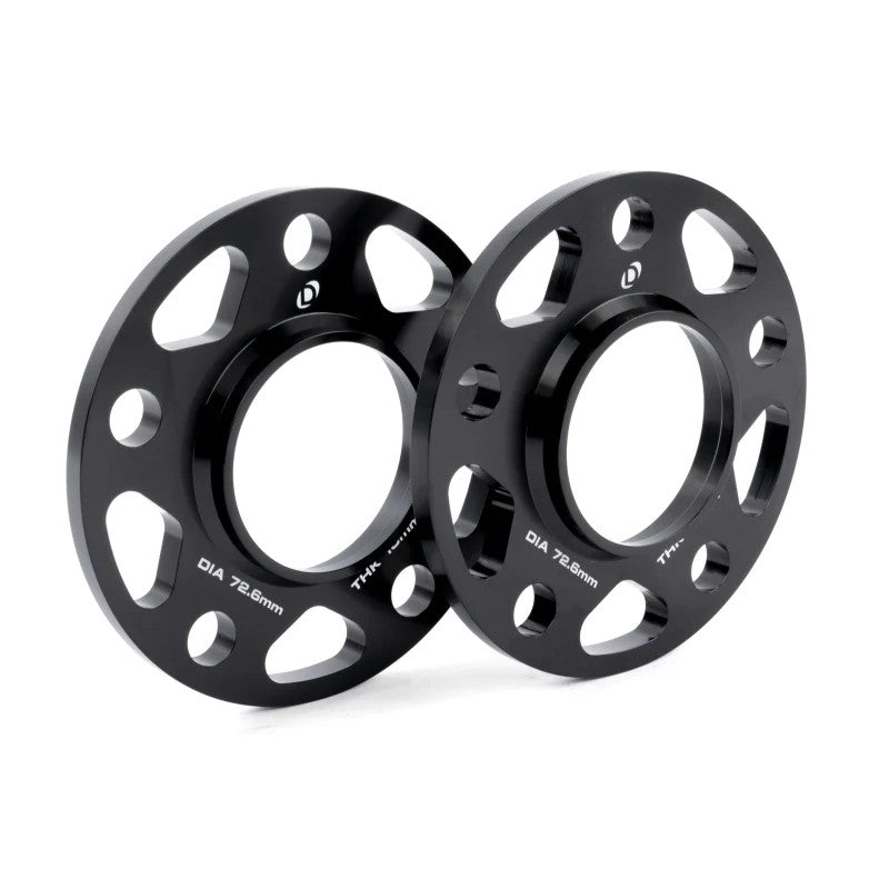 A pair of black anodized Dinan 10mm hub-centric wheel spacers with 5x120 bolt pattern and 72.6mm center bore.