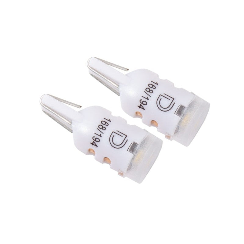 A pair of Diode Dynamics HP5 194 LED bulbs featuring 4000K natural white output and a diffused lens for even light spread.
