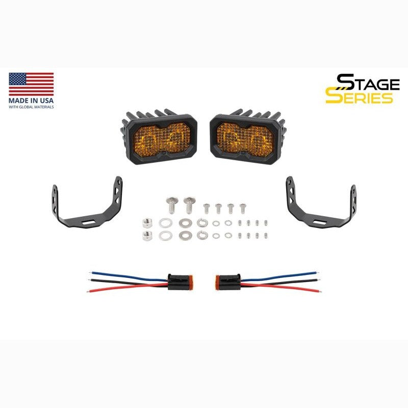 A pair of Diode Dynamics Stage Series C2 2.0 LED pods with yellow lenses and universal mounting brackets.