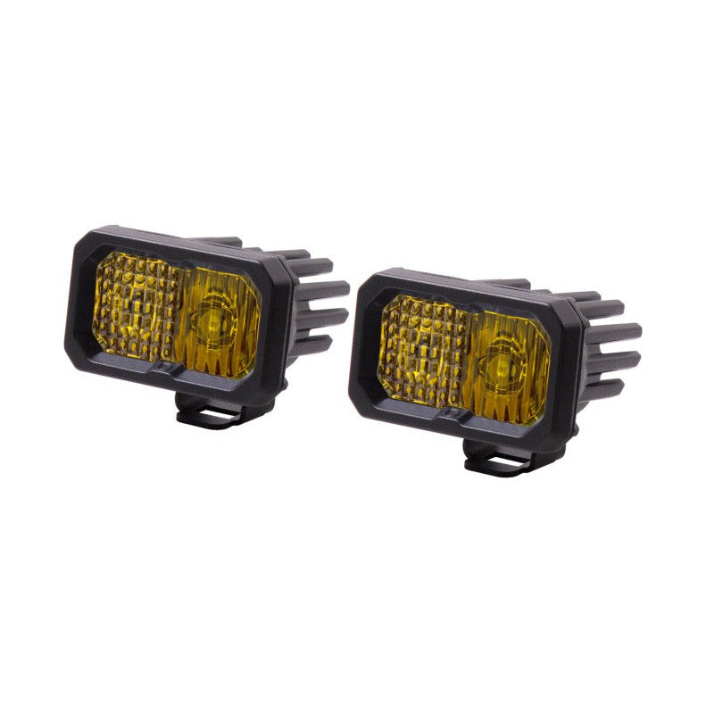 Pair of Diode Dynamics Stage Series 2-inch yellow LED pod lights with black powder-coated aluminum housings.